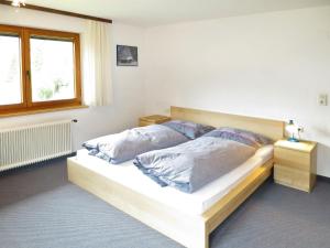 a bedroom with a bed with two pillows on it at Holiday Home Julia by Interhome in Kappl