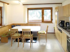 a kitchen with a table and chairs in a room at Holiday Home Julia - KPL641 by Interhome in Kappl