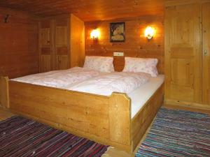 ein großes Holzbett in einem Holzzimmer in der Unterkunft Holiday Home Hexenhäusl - KAB115 by Interhome in Kaltenbach