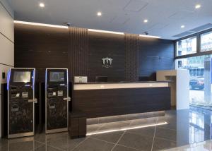 a lobby with two atm machines in a building at Sanco Inn Nagoya Nishiki Shikinoyu in Nagoya