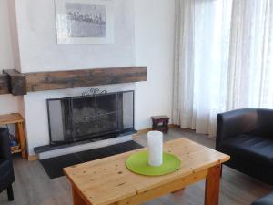 - un salon doté d'une cheminée et d'une table avec une bougie dans l'établissement Apartment Christiania I F6 by Interhome, à Nendaz