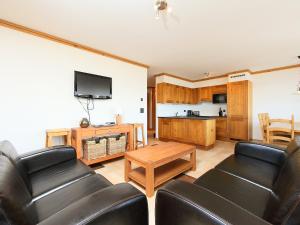 a living room with a couch and a tv at Apartment Les Terrasses du Paradis 5a by Interhome in Nendaz