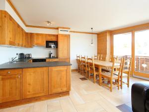 a kitchen and dining room with a table and chairs at Apartment Les Terrasses du Paradis 5a by Interhome in Nendaz