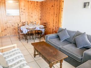 a living room with a couch and a table at Apartment Christiania I I5 by Interhome in Nendaz