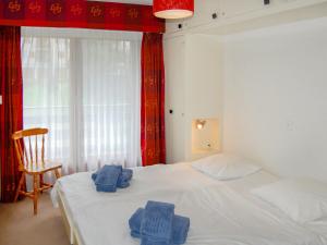 ナンダにあるApartment Panoramic G4 by Interhomeのベッドルーム1室(白いベッド1台、タオル付)