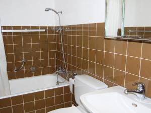 a bathroom with a shower and a toilet and a sink at Apartment Rosablanche D32 by Interhome in Siviez