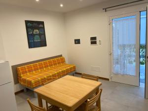 ein Wohnzimmer mit einem Sofa und einem Tisch in der Unterkunft NEW Apartment Diana Ovest in Bibione