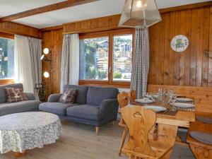 a living room with a couch and a table at Apartment Ecluses 11 by Interhome in Nendaz