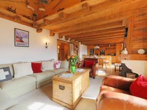 a living room with a couch and a table at Chalet Saint Piran by Interhome in Villars-sur-Ollon