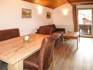 a living room with a wooden table and a couch at Apartment Hof am Schönbach - STA161 by Interhome in Sankt Jakob