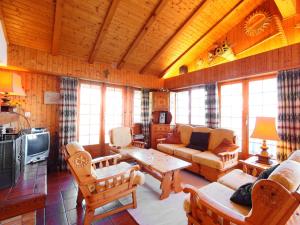 a living room with a couch and a table at Chalet Dejo A Dzeu by Interhome in Nendaz