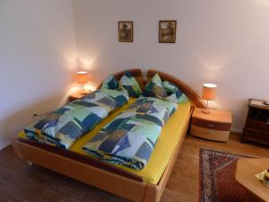 a bedroom with a large bed with blue pillows at Studio Arcadia-1 by Interhome in Leukerbad