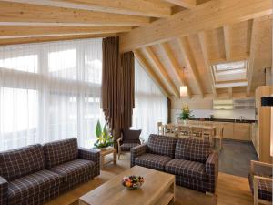 a living room with two couches and a table at Apartment Zur Matte B-11 by Interhome in Zermatt