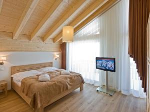 a bedroom with a bed with a television in it at Apartment Zur Matte B-11 by Interhome in Zermatt