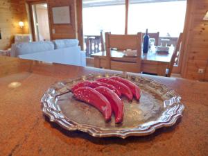 three red bananas on a glass plate on a table at Apartment Rhodonite 33 by Interhome in Villars-sur-Ollon