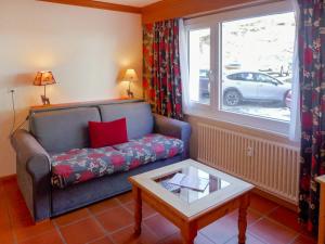 a living room with a couch and a window at Apartment Résidence Christina Apt- 305 by Interhome in Crans-Montana