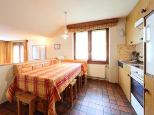 a kitchen with a table and chairs in a kitchen at Apartment Pyrith by Interhome in Zermatt