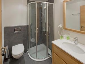 a bathroom with a shower and a toilet and a sink at Apartment Zur Matte B-5 by Interhome in Zermatt