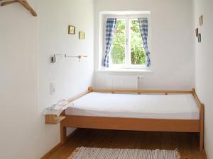 a bed in a room with a window at Chalet Waldweber - SWG100 by Interhome in Kruckenberg