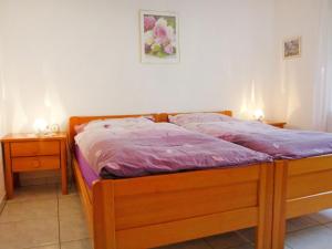 ein Bett in einem Schlafzimmer mit zwei Nachttischen und zwei Lampen in der Unterkunft Apartment Luchre by Interhome in Zermatt