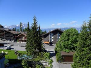 a group of buildings with trees and a parking lot at Apartment Gamat 30 by Interhome in Villars-sur-Ollon