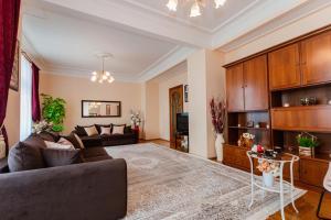 a living room with a couch and a table at Lakshmi Club Apartment 3-bedroom in Moscow