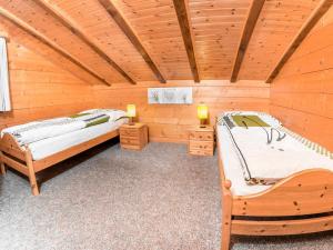 a room with two beds in a log cabin at Apartment Kelly by Interhome in Grächen