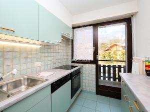 a small kitchen with a sink and a window at Apartment Marignac 33 by Interhome in Villars-sur-Ollon +17 photos