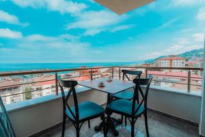a table and two chairs on a balcony with a view at Empula Hotel & Residences in Trabzon