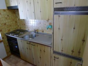 a kitchen with a sink and a stove at Apartment Orion by Interhome in Leukerbad