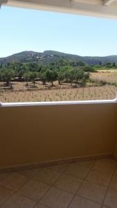 a large window with a view of a field at Emmanouil in Kythira