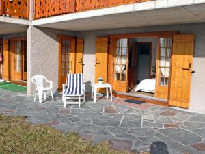 two chairs and a table on a patio at Apartment Argentière 3 by Interhome in Villars-sur-Ollon