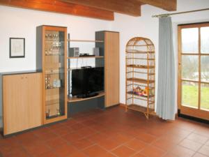 a living room with a flat screen tv and a tv stand at Holiday Home Ilztal by Interhome in Allmunzen