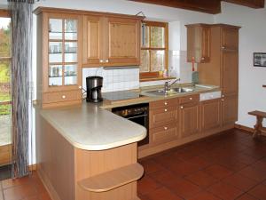 a kitchen with wooden cabinets and a counter top at Holiday Home Ilztal by Interhome in Allmunzen