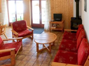 a living room with a couch and chairs and a table at Chalet Basilic by Interhome in Les Collons