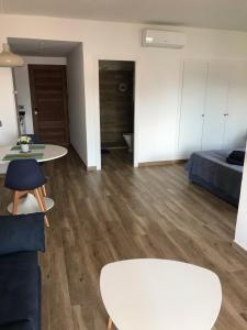 a living room with a white table and a couch at Apartamentos El Bergantin Menorca Club in Fornells