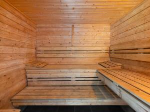 a wooden sauna with a bench in the middle at Holiday Home Haus Polivka - HUR100 by Interhome in Třebíšov