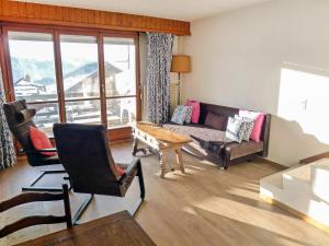 a living room with a couch and a table at Apartment Villars Soleil A27 by Interhome in Villars-sur-Ollon