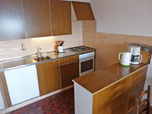 a kitchen with a sink and a stove top oven at Apartment Villars Soleil A27 by Interhome in Villars-sur-Ollon