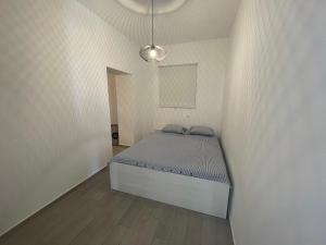 a small bedroom with a bed in a white wall at Apartmani Pulić in Senj