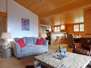 ein Wohnzimmer mit einem Sofa und einem Tisch in der Unterkunft Apartment Le Faucon 8 by Interhome in Villars-sur-Ollon
