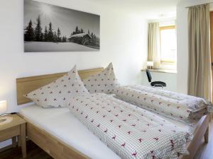 a bedroom with two beds and a picture on the wall at Apartment Lisi - SUZ372 by Interhome in Stummerberg