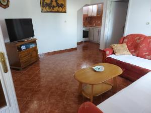 a living room with a couch and a table at Apartmani Jašarević in Martinšćica