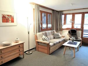 a living room with a couch and a table at Apartment Aragon M86 by Interhome in Fiesch