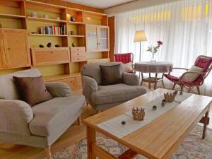 a living room with two couches and a coffee table at Holiday Home Salzhubelweg by Interhome in Goldswil