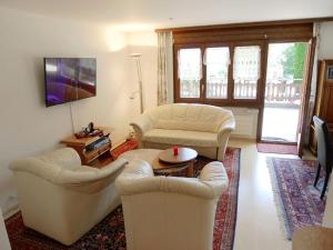 ein Wohnzimmer mit 2 Stühlen und einem Tisch in der Unterkunft Apartment Gemmi by Interhome in Albinen