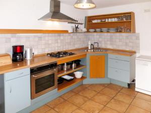 a kitchen with a sink and a stove top oven at Holiday Home Maiergschwendt by Interhome in Ruhpolding