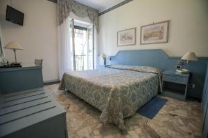 Кровать или кровати в номере Hotel Ariston