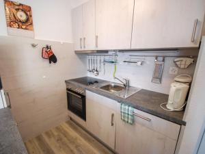 a small kitchen with a sink and a stove at Apartment Les Bouillets by Interhome in Veysonnaz
