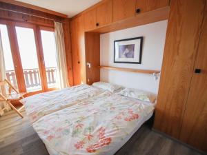 a bedroom with a bed in a room with a window at Apartment Les Bouillets by Interhome in Veysonnaz